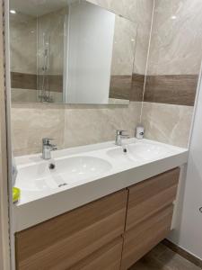 a bathroom with a white sink and a mirror at Maison du Bonheur Newly renovated house, private garden and 12x4m mooring in Port Grimaud