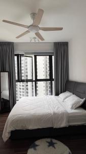 a bedroom with a large bed with a ceiling fan at Geo Bukit Rimau Apartment in Shah Alam +7 photos