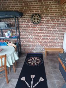 a dart board in a room with a brick wall at De Horizon in de Westhoek in Poperinge