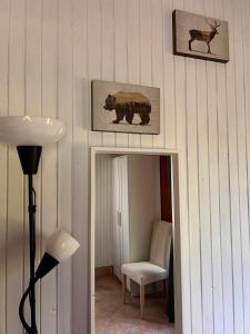 a room with a mirror and a bear and a chair at L'Orsa in Villalago +20 photos