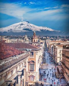 a view of a city with a mountain in the background at MaGa House in Catania