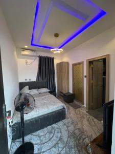 a bedroom with a bed with a blue light at Luxury Self Contain Apartment, City College Karu Abuja 