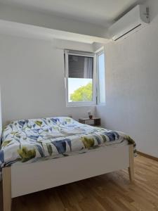 Ένα ή περισσότερα κρεβάτια σε δωμάτιο στο Apartman Tasic