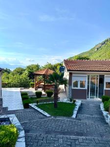 a house with a palm tree in the yard at Apartments Slavica in Ohrid