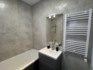 a bathroom with a sink and a bath tub at AT Modern Boutique in Bucharest +37 photos