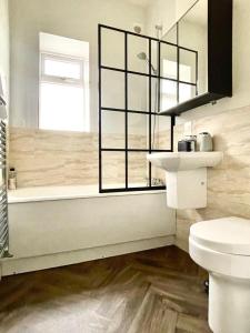 a bathroom with a sink and a toilet and a window at Wild Springs - Centraly Located House With Free Parking in Wetherby