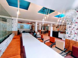 a dining room with a long table and chairs at Hotel Apex Intercontinental in Jaipur