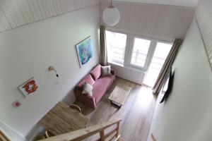 an overhead view of a living room with a pink couch at Vila Pakaso malūnas in Kirdeikiai