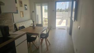 a kitchen with a table and chairs and a view of a patio at Golf residence in Ardea
