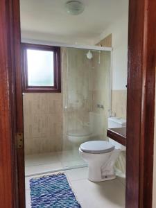a bathroom with a toilet and a shower and a sink at CasaLegal in Búzios +23 photos