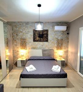 a bedroom with a bed and two night stands at Chalet Ponte Paradiso Suite & SPA in Santa Cristina Gela