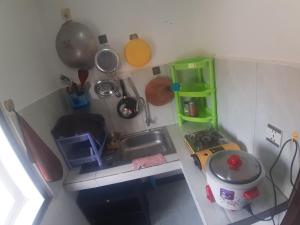 a miniature kitchen with a sink and utensils at Homestay 1-2pax AC room 3 including private kitchen in Siem Reap