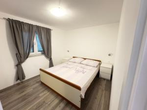 a bedroom with a bed and a large window at Apartman Meld in Vrh