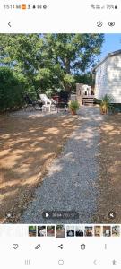 a picture of a yard with a bench and a building at charmant mobil home de patricia et bruno in Sainte-Croix-de-Verdon