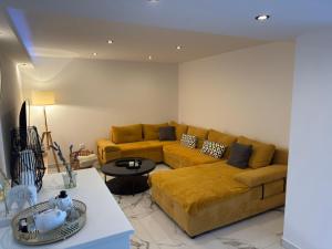 a living room with a couch and a table at Apartman Meld in Vrh