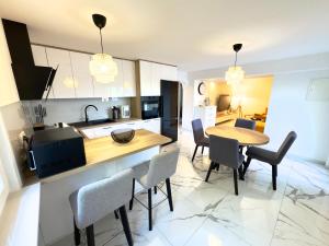 a kitchen and dining room with a table and chairs at Apartman Meld in Vrh +7 photos