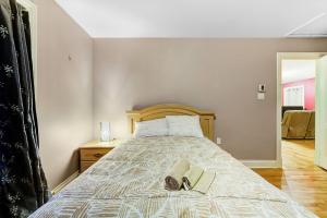 a bedroom with a bed with two slippers on it at Cozy Chalet Val Morin in Val-Morin +3 photos