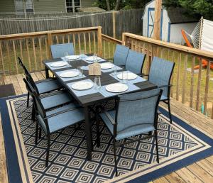 a black dining table and chairs on a deck at 3br-2ba I amazing outdoors I close to everything in Rehoboth Beach
