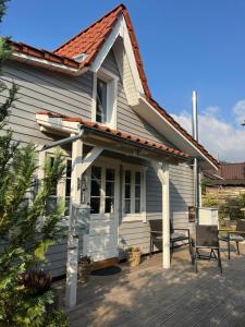 a white house with a porch and a patio at Ferienhaus Emma in Langelsheim