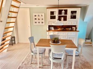 a kitchen and dining room with a wooden table and chairs at Ferienhaus Emma in Langelsheim +18 photos