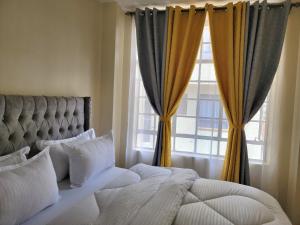 Postel nebo postele na pokoji v ubytování Cozy Apartment