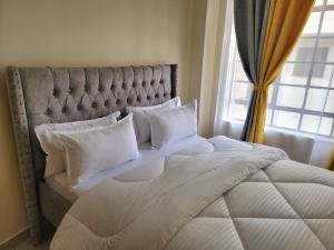 Postel nebo postele na pokoji v ubytování Cozy Apartment