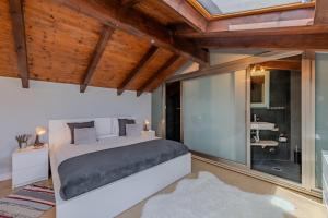 a bedroom with a bed and a large glass window at Bela Vista Exclusive Private Villa in Praia da Luz in Luz +67 photos