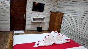 a room with two white shoes on a bed at Oka Cottage in Nusa Penida