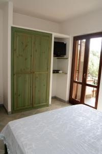 a bedroom with a bed and a sliding glass door at RESIDENCe SANTA CLARA in Marina di Camerota