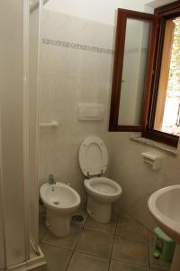 a bathroom with a toilet and a sink at RESIDENCe SANTA CLARA in Marina di Camerota +49 photos