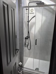a shower with a glass door in a bathroom at Digital Nomad Studio in Norwich