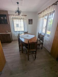 a dining room with a wooden table and chairs at Apartment In Pinosava in Pinosava +2 photos