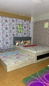 a bedroom with two beds in a room at Cabongaoan Beach, Burgos, Pangasinan 