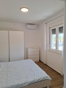 Postel nebo postele na pokoji v ubytování Apartman Damir