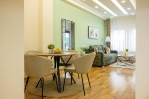 a living room with a table and chairs and a couch at Cherry Lux Apartments in Arandelovac