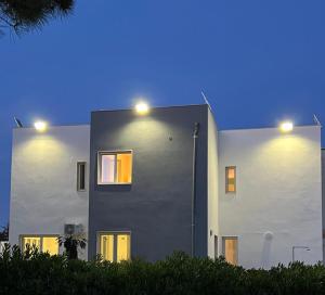 a house with lights on the side of it at A 100 passi dal mare in Bari
