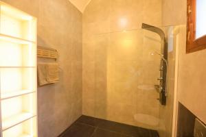 a shower with a glass door in a bathroom at Desert Rose apartment's in Luxor +58 photos