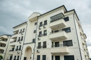 an apartment building with balconies on the side of it at Cherry Lux Apartments in Arandelovac