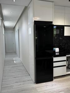 a kitchen with a large black and white refrigerator at Eron Villas Velipoje in Velipojë