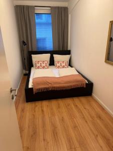 a bedroom with a bed with two pillows on it at Altstadtinsel am Johanneum 22 in Lübeck