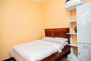 a small bedroom with a bed and shelves at Pundamilia Private rooms in Kikuyu +8 photos