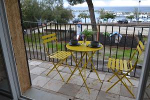 a yellow table and chairs on a balcony at Cap Corse-Santa Severa, grande appartamento vista mare in Luri +51 photos