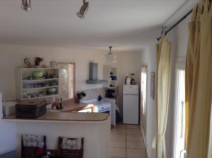 a kitchen with a counter and a white refrigerator at Cap Corse-Santa Severa, grande appartamento vista mare in Luri