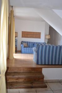a living room with a couch and a table at Cap Corse-Santa Severa, grande appartamento vista mare in Luri