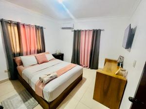 a bedroom with a bed in a room at Brisas de las Montañas in Jarabacoa