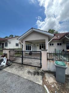 a house with a fence in front of it at Almai Homestay Batu 4 in Port Dickson