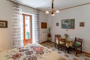 a bedroom with a bed and a table and a window at CristallPont AmalfiDay in Atrani