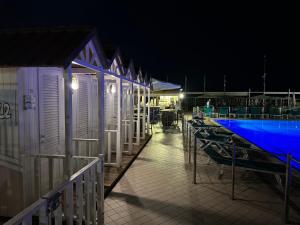 a row of portable toilets and a pool at night at L'ARCO E' DI FIO in Camaiore
