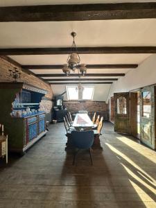 a dining room with a table and chairs at Castle View Saschiz - Traditional Guesthouse in Saschiz