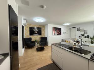 a kitchen with a sink and a living room at Abades confort & luxury in Abades